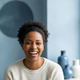A diverse, authentic headshot portrait of a happy customer smiling confidently.